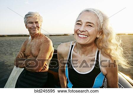 Older Caucasian couple leaning on convertible car at beach View Large Photo Image Stock Photography - Older Caucasian couple leaning on convertible car at beach. Fotosearch