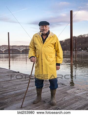 Older Caucasian fisherman standing on dock View Large Photo Image Stock Image - Older Caucasian fisherman standing on dock. Fotosearch