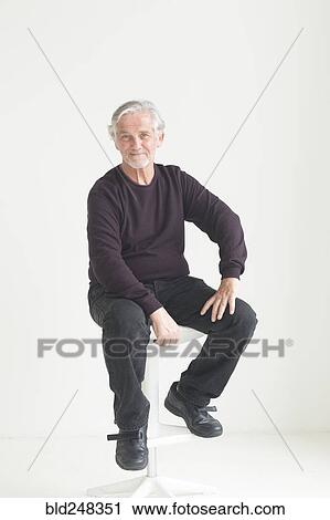 Older Caucasian man sitting on stool View Large Photo Image Stock Image - Older Caucasian man sitting on stool. Fotosearch