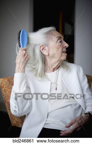 Older Caucasian woman brushing hair View Large Photo Image Stock Image - Older Caucasian woman brushing hair. Fotosearch