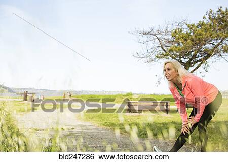 Older Caucasian woman stretching leg in park View Large Photo Image Stock Photograph - Older Caucasian woman stretching leg in park. Fotosearch