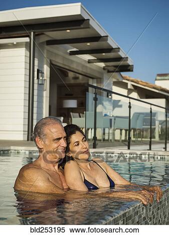 Older couple relaxing in swimming pool View Large Photo Image Stock Photography - Older couple relaxing in swimming pool. Fotosearch