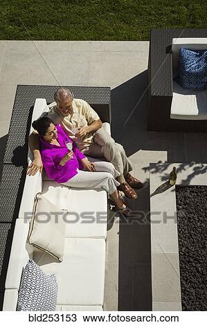 Older couple relaxing on modern backyard patio View Large Photo Image Stock Image - Older couple relaxing on modern backyard patio. Fotosearch
