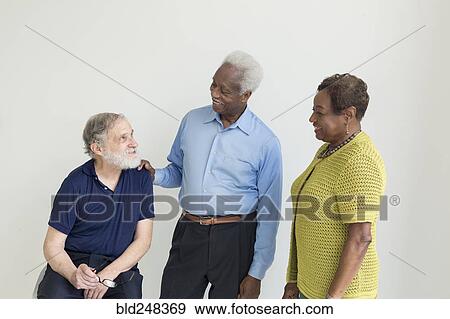 Older couple talking to friend View Large Photo Image Stock Photo - Older couple talking to friend. Fotosearch