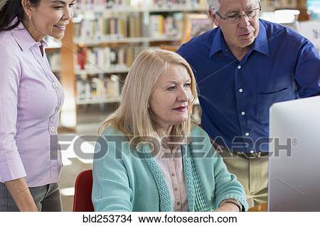 Older people using computer in library View Large Photo Image Picture - Older people using computer in library. Fotosearch