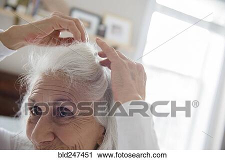 Older woman arranging hair View Large Photo Image Stock Image - Older woman arranging hair. Fotosearch