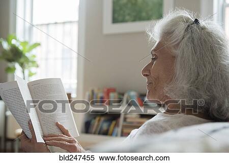 Stock Photography - Older woman reading book. Fotosearch