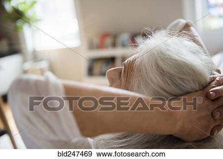 Older woman relaxing with hands behind head View Large Photo Image Stock Photo - Older woman relaxing with hands behind head. Fotosearch