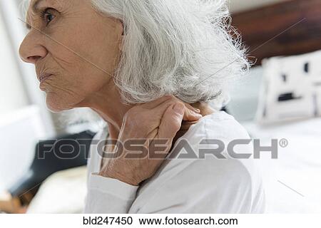 Older woman rubbing the neck View Large Photo Image Stock Image - Older woman rubbing the neck. Fotosearch