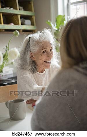 Older woman talking with daughter View Large Photo Image Stock Photo - Older woman talking with daughter. Fotosearch