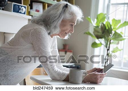 Older woman texting on cell phone View Large Photo Image Stock Photo - Older woman texting on cell phone. Fotosearch