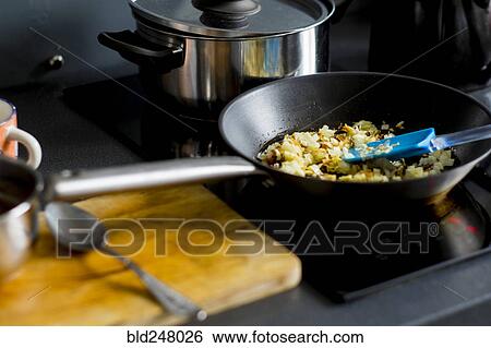 Onions cooking in pan on stove View Large Photo Image Stock Photograph - Onions cooking in pan on stove. Fotosearch