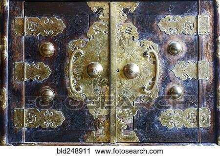 Stock Image - Ornate handles on doors. Fotosearch