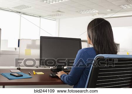 Pacific Islander woman using computer in office View Large Photo Image Stock Photo - Pacific Islander woman using computer in office. Fotosearch
