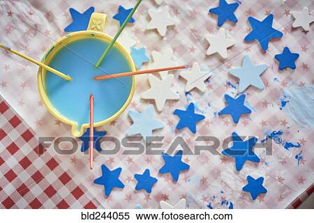 Paintbrushes and blue stars on table View Large Photo Image Stock Photography - Paintbrushes and blue stars on table. Fotosearch