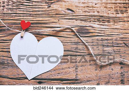 Picture - Paper heart hanging on string with clothespin. Fotosearch