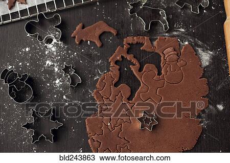 Stock Image - Pastry cutters and gingerbread dough. Fotosearch