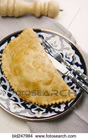 Picture - Pastry on plate with fork and knife. Fotosearch
