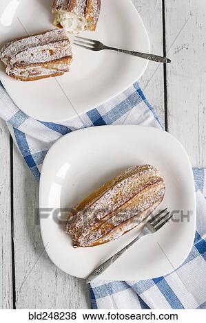 Stock Photo - Pastry with powdered sugar on plate with fork. Fotosearch