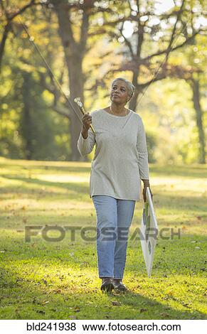 Pensive Black woman carrying paintbrushes and canvas in park View Large Photo Image Stock Photo - Pensive Black woman carrying paintbrushes and canvas in park. Fotosearch