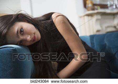 Pensive Caucasian girl resting head on armchair View Large Photo Image Picture - Pensive Caucasian girl resting head on armchair. Fotosearch
