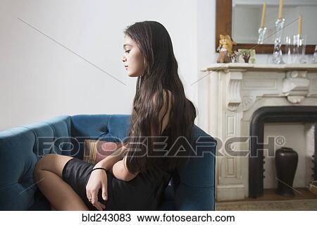 Pensive Caucasian girl sitting in armchair View Large Photo Image Stock Image - Pensive Caucasian girl sitting in armchair. Fotosearch