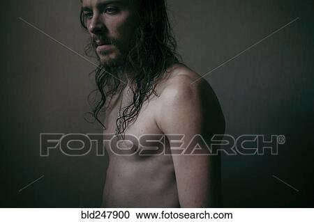 Pensive Caucasian man with long hair and bare chest View Large Photo Image Stock Image - Pensive Caucasian man with long hair and bare chest. Fotosearch