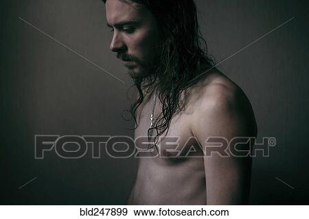Pensive Caucasian man with long hair and bare chest View Large Photo Image Stock Photo - Pensive Caucasian man with long hair and bare chest. Fotosearch