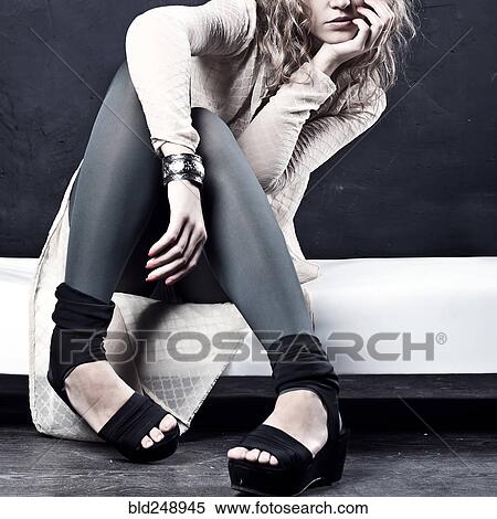 Stock Photography - Pensive Caucasian teenage girl wearing high heels. Fotosearch