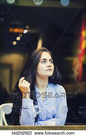 Pensive Caucasian woman drinking coffee at cafe View Large Photo Image Stock Image - Pensive Caucasian woman drinking coffee at cafe. Fotosearch