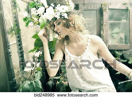 Stock Photography - Pensive Caucasian woman sitting in garden. Fotosearch