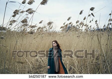 Pensive Caucasian woman standing in field View Large Photo Image Stock Photo - Pensive Caucasian woman standing in field. Fotosearch