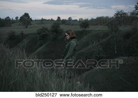 Pensive Caucasian woman standing on hill View Large Photo Image Stock Photo - Pensive Caucasian woman standing on hill. Fotosearch