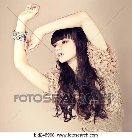 Stock Photo - Pensive Caucasian woman wearing ruffled sweater. Fotosearch