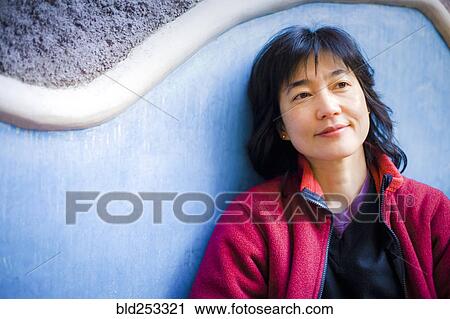 Pensive Japanese woman leaning on wall View Large Photo Image Stock Image - Pensive Japanese woman leaning on wall. Fotosearch