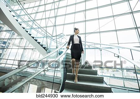 Pensive Mixed Race businesswoman descending staircase View Large Photo Image Stock Image - Pensive Mixed Race businesswoman descending staircase. Fotosearch