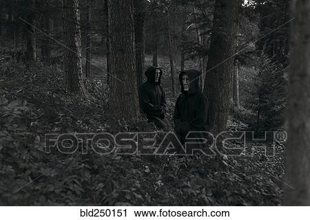 People wearing black robes and white masks sitting in forest View Large Photo Image Stock Image - People wearing black robes and white masks sitting in forest. Fotosearch