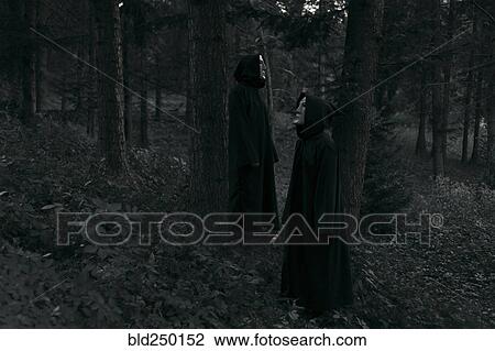 People wearing black robes and white masks standing in forest View Large Photo Image Stock Image - People wearing black robes and white masks standing in forest. Fotosearch