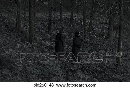 People wearing black robes and white masks in forest View Large Photo Image Stock Photo - People wearing black robes and white masks in forest. Fotosearch