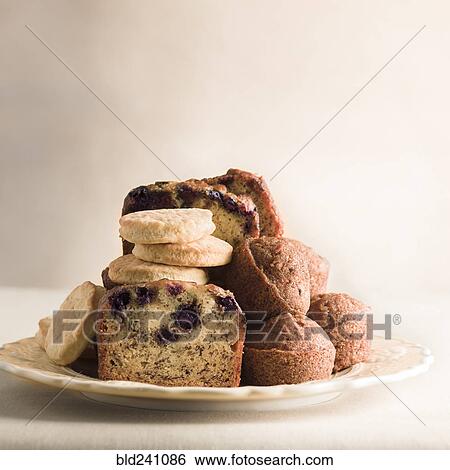 Pile of cookies and breakfast bread on plate View Large Photo Image Stock Photograph - Pile of cookies and breakfast bread on plate. Fotosearch