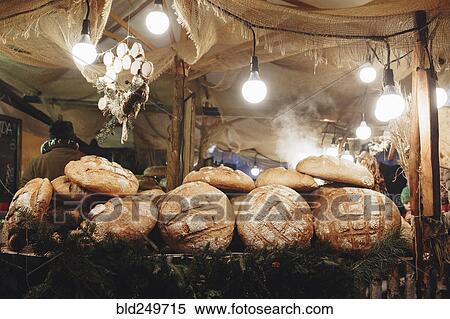 Stock Photography - Pile of loaves of bread on table in tent. Fotosearch