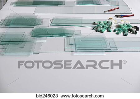 Piles of glass and glass cutter on white table View Large Photo Image Stock Image - Piles of glass and glass cutter on white table. Fotosearch