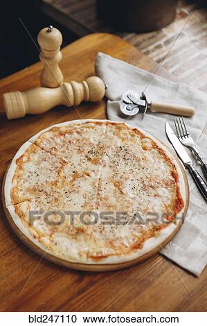 Pizza pie on table View Large Photo Image Stock Image - Pizza pie on table. Fotosearch