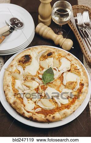 Pizza pie on table View Large Photo Image Stock Photo - Pizza pie on table. Fotosearch