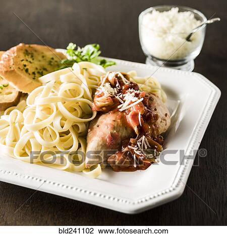 Plate of chicken and pasta with bread View Large Photo Image Stock Image - Plate of chicken and pasta with bread. Fotosearch