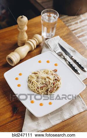 Plate of pasta on table View Large Photo Image Stock Image - Plate of pasta on table. Fotosearch
