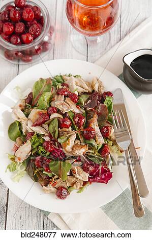 Stock Photo - Plate of salad with chicken and cherry sauce. Fotosearch