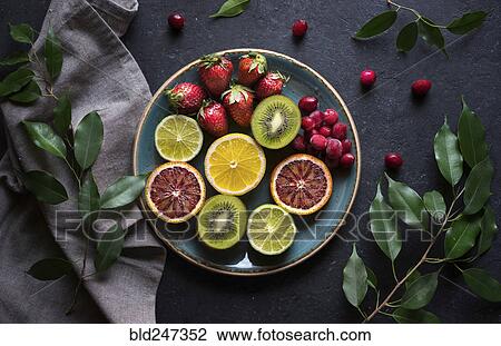 Plate of sliced fresh fruit View Large Photo Image Stock Image - Plate of sliced fresh fruit. Fotosearch
