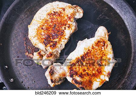 Pork chops searing in pan View Large Photo Image Stock Photo - Pork chops searing in pan. Fotosearch