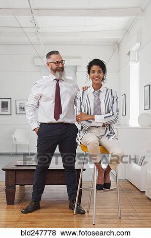 Stock Photo - Portrait of a smiling businessman and businesswoman. Fotosearch